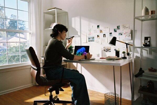 Person working at desk with laptop and phone